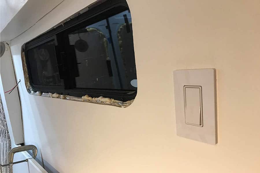Camper van wall with a light switch and window
