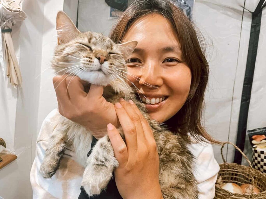 Woman holding a cat in a camper van