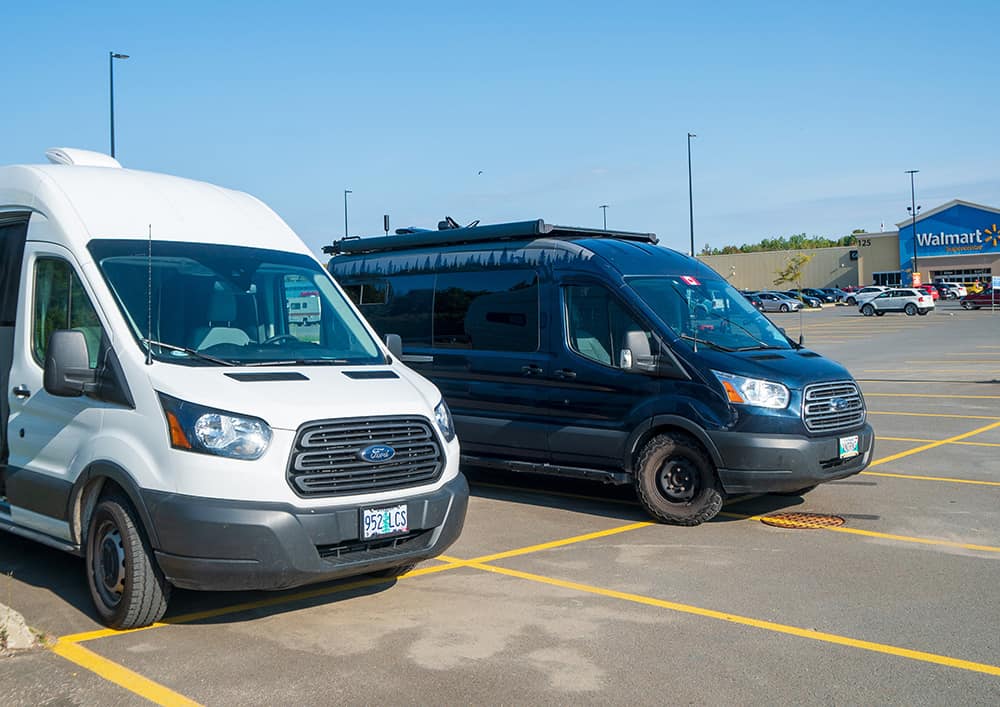 Two camper vans parked at a Walmart parking lot