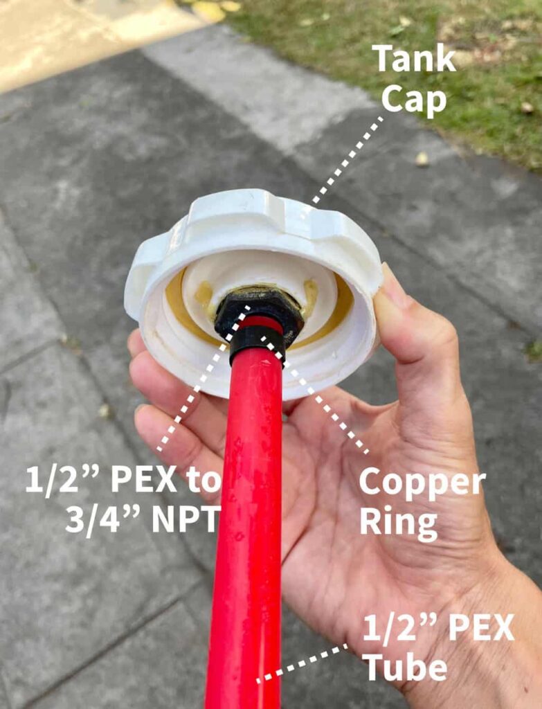 Showing how to insert a metal plumbing fitting through the water container cap