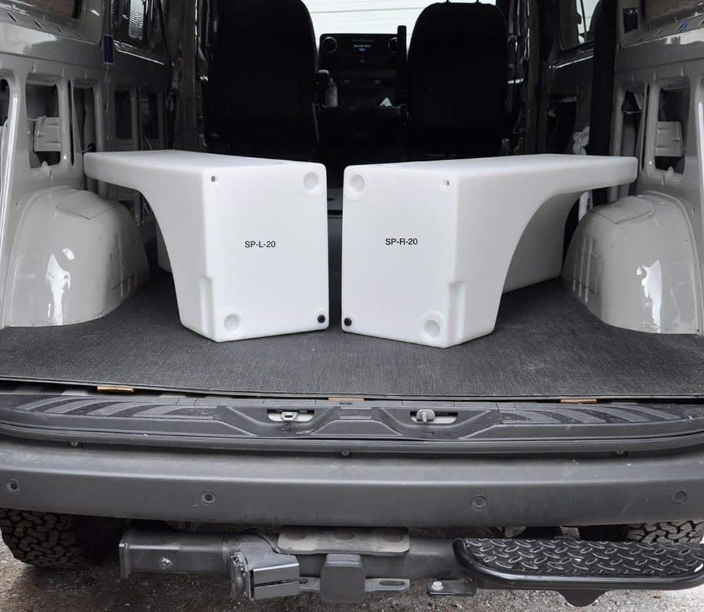 Water tanks that fit over the wheel wells of vans.