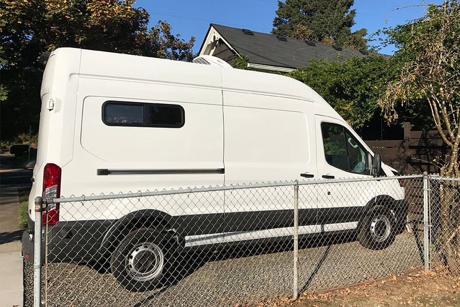 Ford Transit camper van with RV windows installed in the back panel