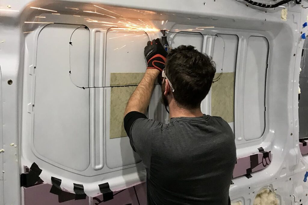 Friend cutting off the vertical support beams with an angle grinder