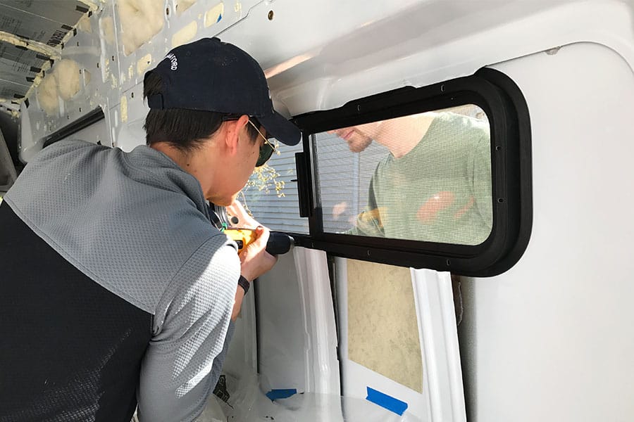 Eric installing an RV window in a camper van