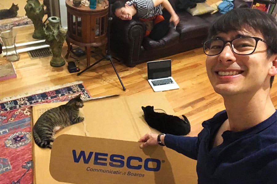 Holding up the cardboard template for our windows