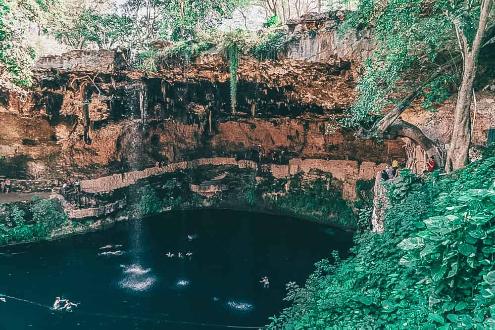 Pool below the ground with people swimming inside