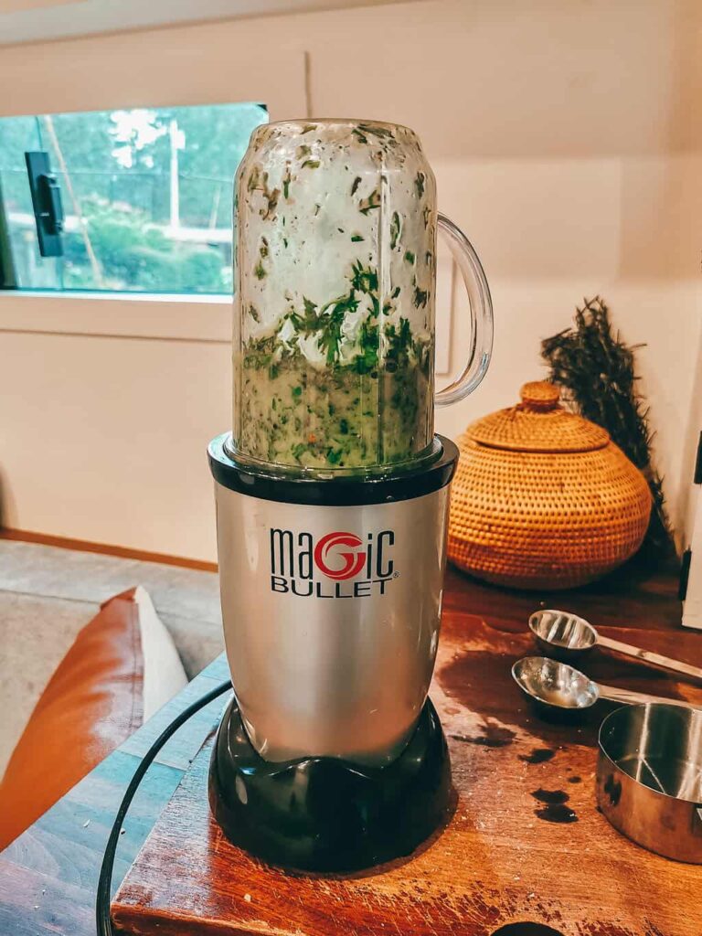 Magic bullet blender making pesto sauce